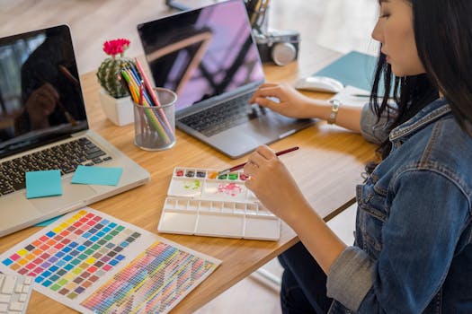 a workspace with a laptop and digital art on the screen