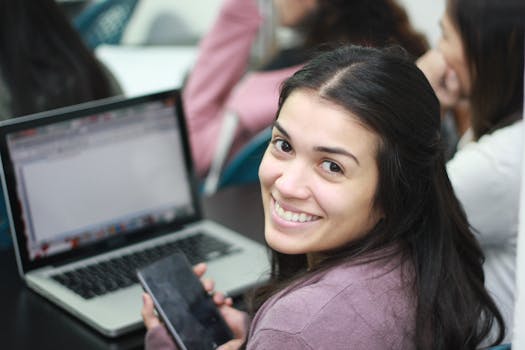 happy college student working on a laptop