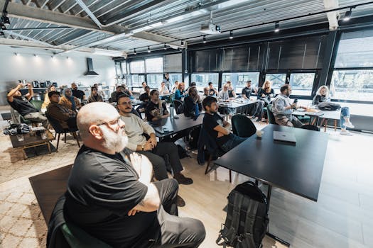 A diverse group of people listening to a business pitch