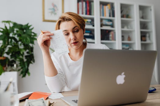 freelancer updating budget on laptop