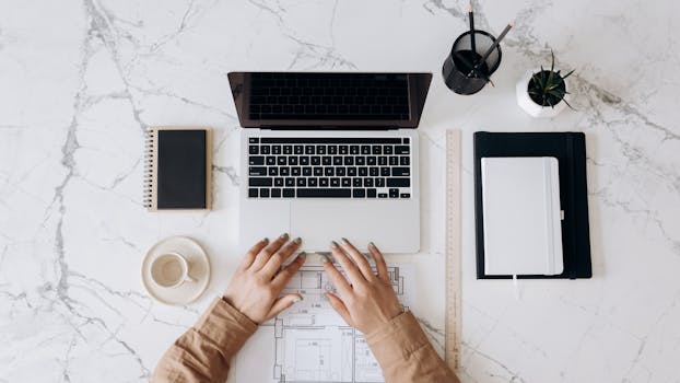 image of a person working on their laptop at a coffee shop