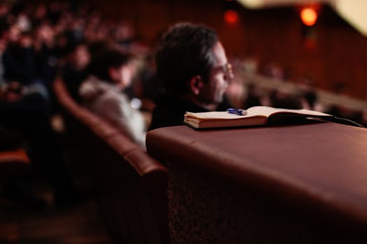 person taking notes while listening to a podcast